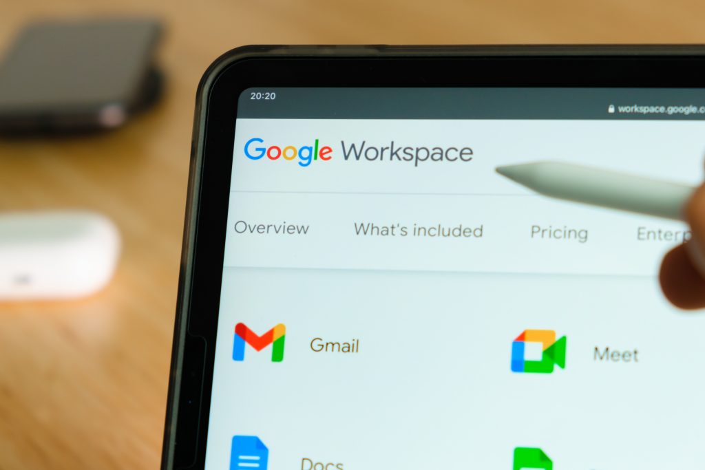 Google Workspace logo shown by apple pencil on the iPad Pro tablet screen. Man using application on the tablet. December 2020, San Francisco, USA
